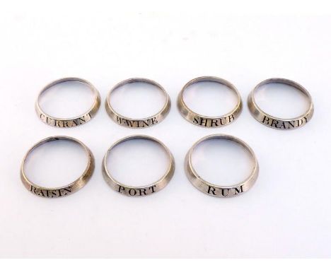 A set of 7 Old Sheffield Plate decanter neck rings, circa 1800, incised "CURRANT", "PORT", "W.WINE", "SHRUB", "RAISIN", "BRAN