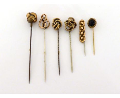 A group of late Victorian yellow metal stick pins, including one hallmarked as 9 carat gold, each on a base metal pin (6)COND