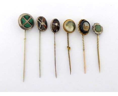 A group of late Victorian hardstone set stick pins, including a micro-mosaic example depicting the Colosseum in Rome, a bande