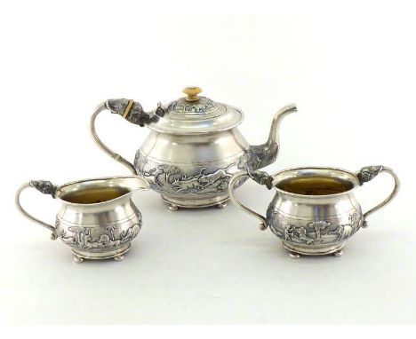 An Indian silver three-piece teaset, unmarked except for an indistinct punch to teapot handle, probably Bombay, circa 1900, b