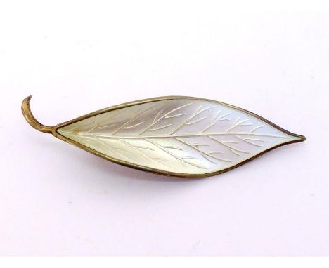 A silver gilt and white enamel brooch by David Andersen, modelled as a leaf, signed and stamped 'NORWAY-STERLING', 6.5cm long
