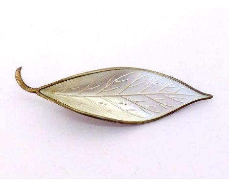 A silver gilt and white enamel brooch by David Andersen, modelled as a leaf, signed and stamped 'NORWAY-STERLING', 6.5cm long