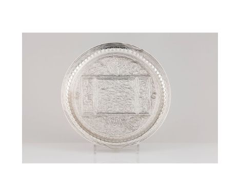 A salverOriental silverCentre profusely engraved with orientalist motifsMiddle East, first-half 20th centuryUnmarkedDiam: 26,