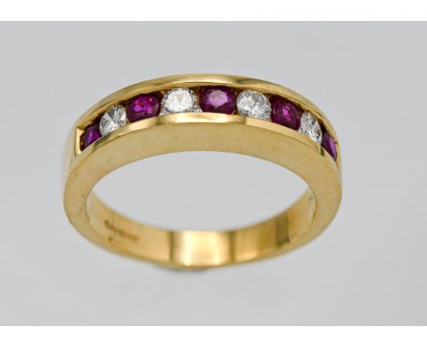 An 18ct ruby and diamond  half band eternity ring set with nine stones. Size M.