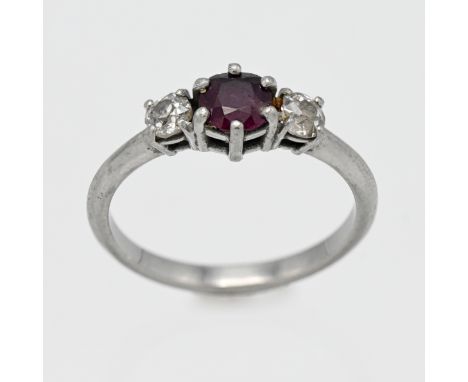 A white gold ruby and diamond three stone ring, centre round cut ruby, with two old cut diamonds to the shoulders, size M (no