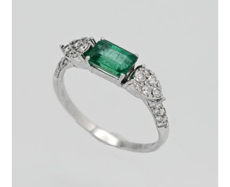 An 18ct white gold emerald and diamond ring. Size P.