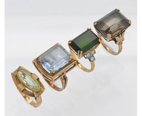 A group of four vintage large stone set rings comprising two 9ct rings (14.70g), an 18ct ring (7.5g) and an unmarked ring (4.