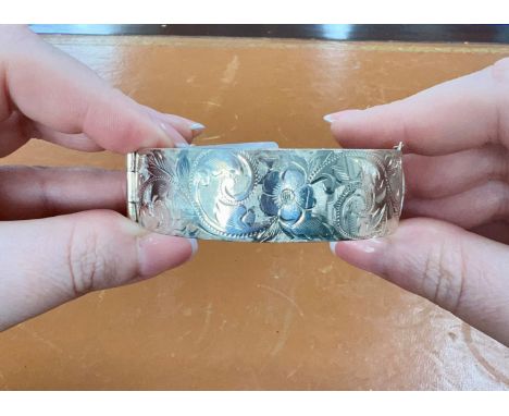 A silver and engraved bangle, 58.20g