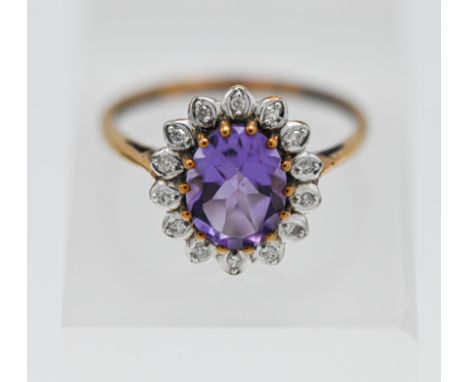 A 9ct amethyst and diamond cluster ring, size N.
