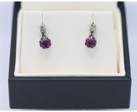 A pair of 9ct white gold ruby and diamond drop earrings.