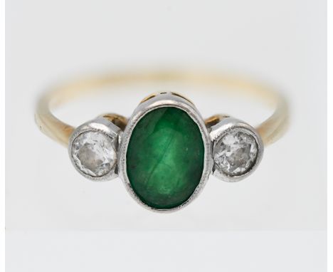 A 18ct gold emerald and diamond three stone ring, the emerald approx. 1.25ct, the diamonds approx. 0.40ct total, size O. with