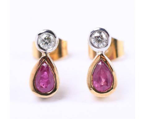 18 carat bicolor stud earrings, each set with an oval cut ruby and brilliant cut diamond of approx. 0.04 ct. Color approx. G-