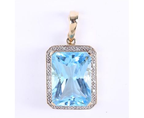 14 carat yellow gold pendant set with an emerald cut aquamarine of approximately 1.8 x 1.3 cm. Surrounded by approximately 14