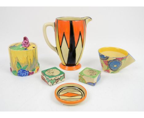 Clarice Cliff Bizarre jug with geometric design, h15.5cm, a Bizarre My Garden honey pot with cover, a conical cup with triang