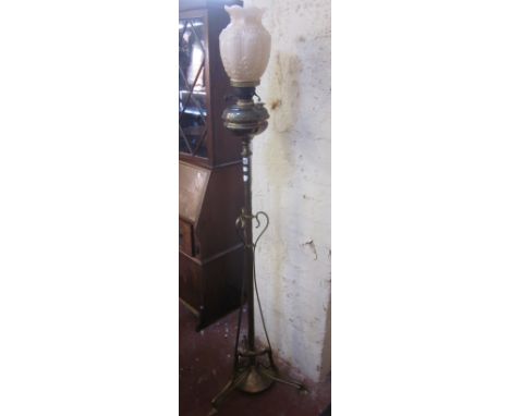 A late Victorian floor standing brass column oil lamp with triform base and pink shade 161cm high 