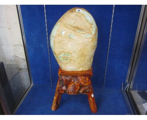 A large rough Jade boulder, on stand, 42cm high not including stand
