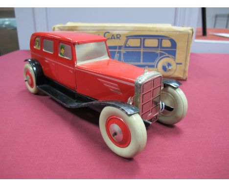 A 1946 Tinplate Clockwork Saloon Car by Chad Valley, finished in red with passengers to windows. Very good plus. With box.