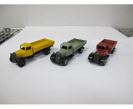Three Original Dinky #25E Tipping Wagons, one type three black chassis, yellow body with paint touch ups , black ridged hubs,