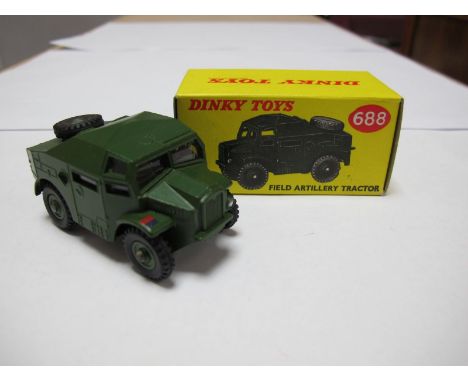 A Boxed Original Dinky #688 Field Artillery Tractor, olive drab body and plastic hubs, windows with driver figure, model good