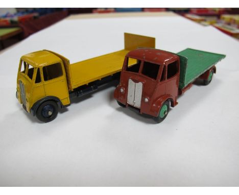 Two Original Dinky Guy Lorries, #512 Guy Flat Truck, first type brown cab and chassis, mid green flatbed and hubs, spare whee