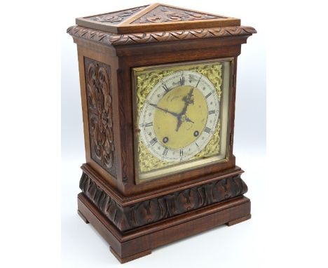 A carved walnut Winterhalder & Hofmeier mantle clock with brass & silvered dial, 360mm high x 254mm wide x 180mm deep