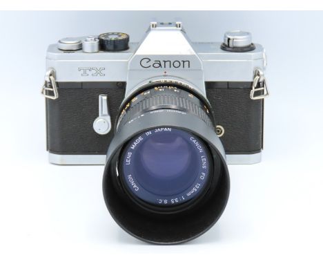 A Canon TX 35mm film camera with Canon FD 135mm lens & Canon hard leather case, serial no. 117789