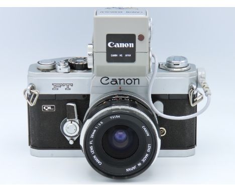 A Canon FT 35mm film camera with original box & manual along with Canon FL 28mm lens, Canon booster & Canon hard leather case