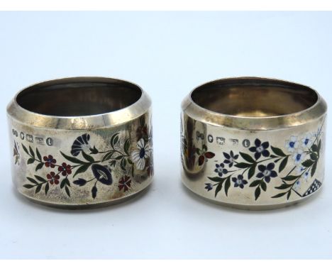 A Victorian pair of Birmingham silver enamelled napkin rings, decorated with flowers & butterflies, by Elkington & Co. dating