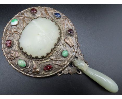 An antique Chinese jade & silver on copper mounted mirror with belt hook handle set with semi precious stones. Handle has car