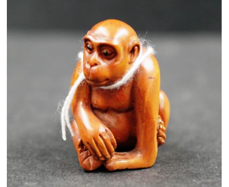 Japanese boxwood netsuke carving of a monkey signed to base, height 4cm approx