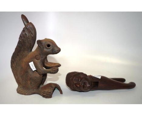 Two good vintage nutcrackers Cast iron squirrel nut cracker together with a Black forest wooden novelty nutcracker