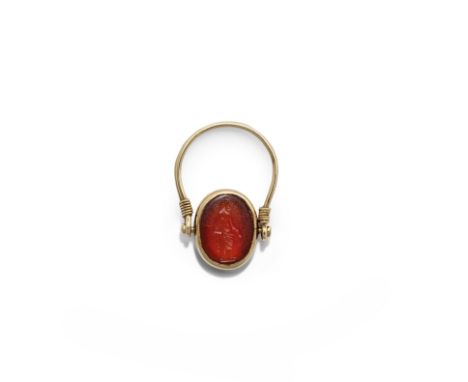  A Roman carnelian intaglio with Serapis  Circa 1st-2nd Century A.D.Carved with the standing figure of the bearded god, holdi