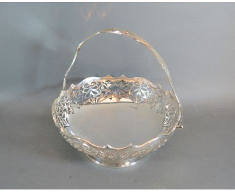 A Sheffield silver bowl of pierced form with swing handle, makers J R, 25oz 