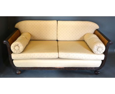 A French Bergere Three Piece Suite comprising a Sofa and two matching Armchairs all with double caned sides and with scroll e