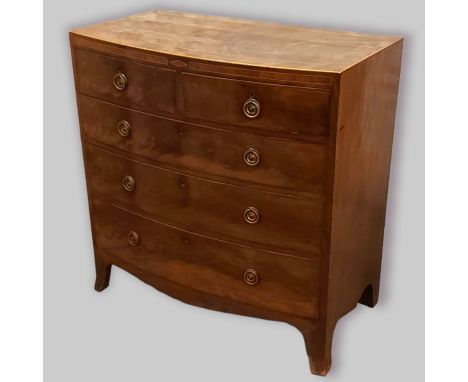 A 19th Century mahogany and inlaid bow fronted chest with two short and three long drawers with circular brass handles raised