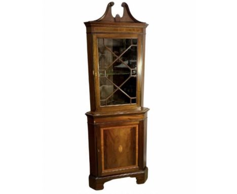 An Edwardian glazed display cabinet, broken swan neck pediment above traditional moulded cornice, frieze with alternating inl