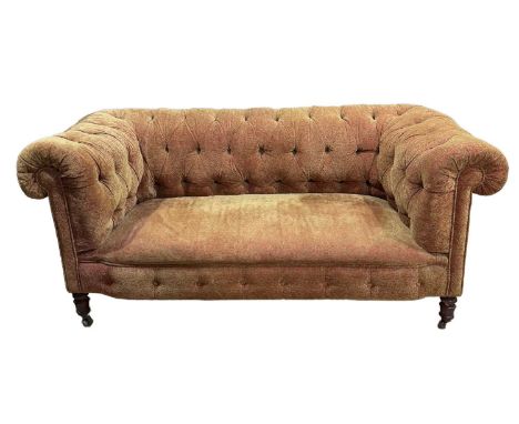 19th or early 20th century two seater chesterfield sofa, covered with a modern terracotta and gold fabric on turned legs down