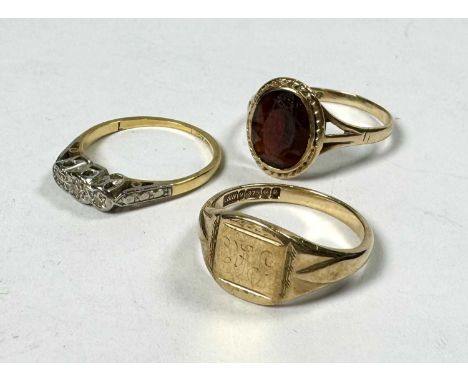 Three gold rings, to include an 18ct gold diamond three-stone ring, all with hallmarks, ring sizes K to N, total weight 7g