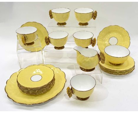 An Aynsley 'Butterfly' tea service, c.1930, naturalistically moulded to resemble open flowers with relief moulded handles, pa