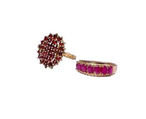 A gold coloured metal oval-shape ruby half eternity ring, together with a silver gilt garnet cluster ring, total weight 5.6g