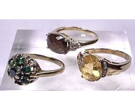 Two gold coloured metal quartz dress rings, together with a gold coloured metal green gem cluster ring, total weight 9.8g