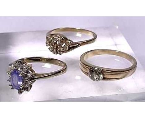 Three gold coloured diamond and gem-set rings, to include an old-cut diamond single-stone band ring and two further rings, es