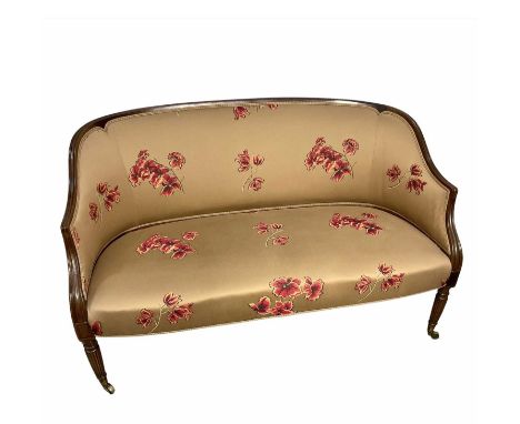 Small mahogany framed salon sofa, possibly French, reeded legs on brass casters, covered in a floral fabric, 86cm high, 70cm 