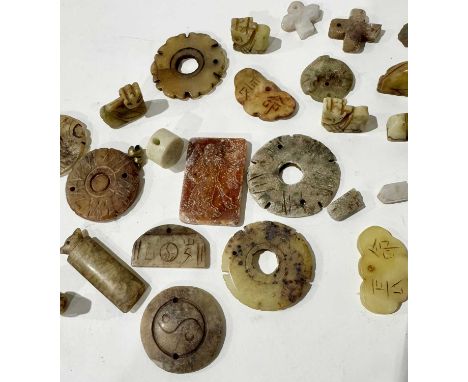 A collection of carved hardstone jade/nephrite-type figurines and pendants many of chrysanthemum and animal form some carved 