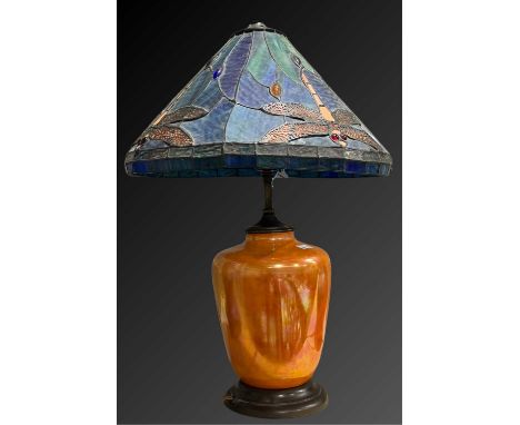 A Ruskin Pottery orange lustre lamp base, with Tiffany style leaded glass shade, shouldered form on turned wooden base, the s