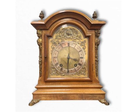 A walnut bracket clock, (movement stamped W&amp;H SCH for Winterhalder &amp; Hofmeier) early 20th Century, the arched case is