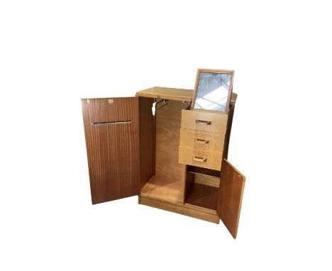 An oak G-Plan tallboy, mid-century, three short drawers, top drawer with pullout mirror, above cupboard opening to single she