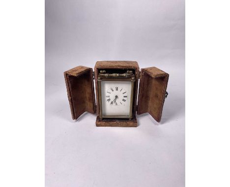 A travel/carriage clock, Roman numeral dial, 10cm high, with original leather and velvet covered case and key