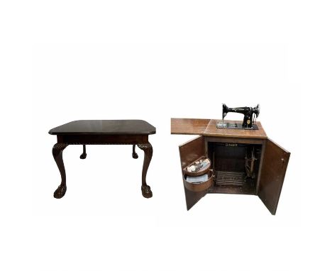 An Oak Singer cupboard, 102cm high, 57cm wide, 104cm wide with folded worktop and sewing machine together with a large Georgi