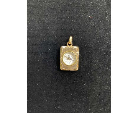 A yellow metal compass fob with engraved design to reverse, 2.5 by 2cm